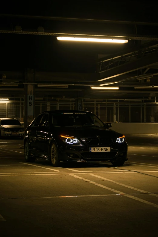 a car that is driving at night in the parking lot