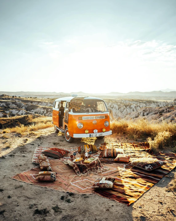 a van is parked on a patch of sand in a field