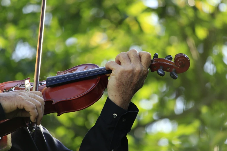 the person is playing on his violin