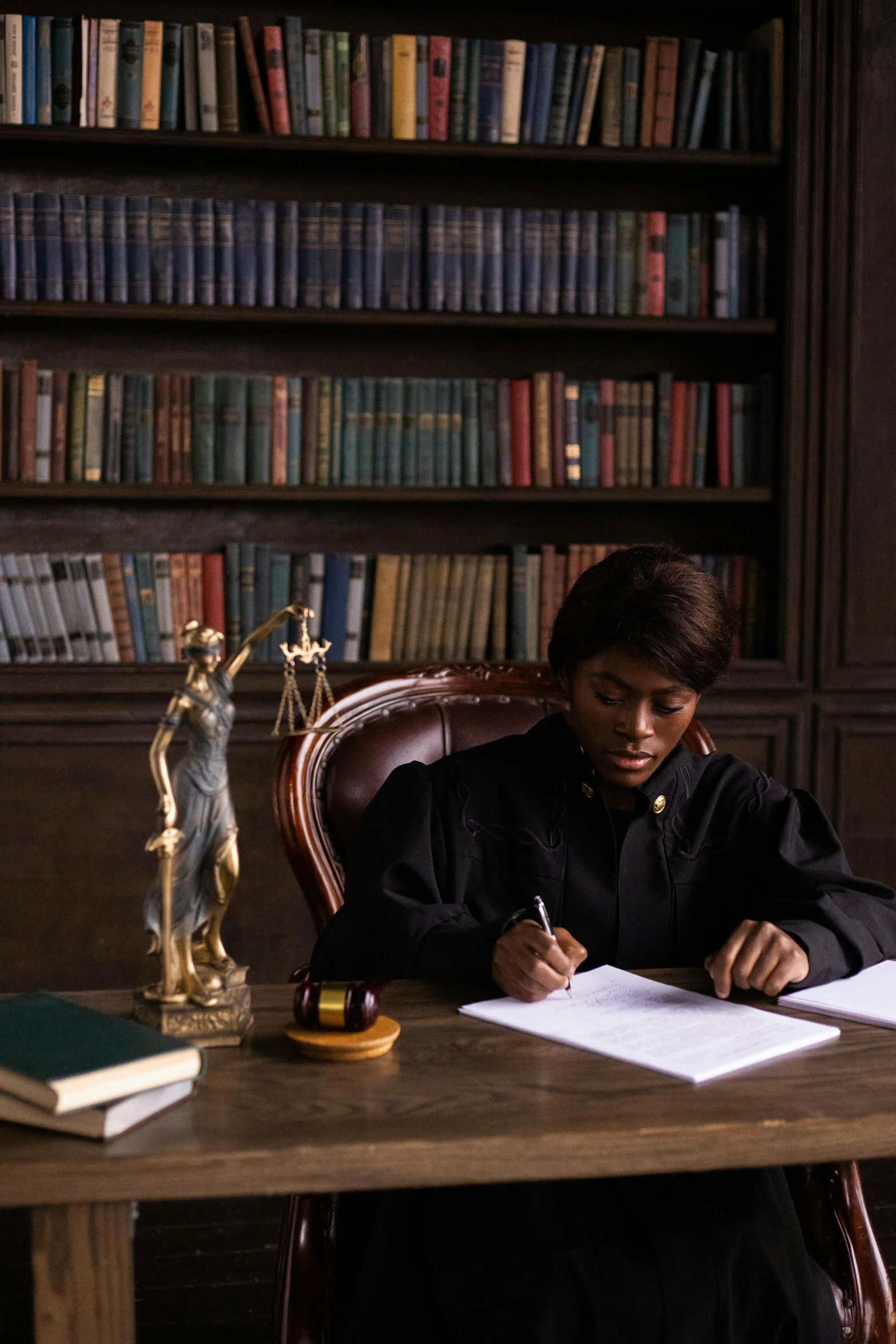 a person is sitting at a desk and writing