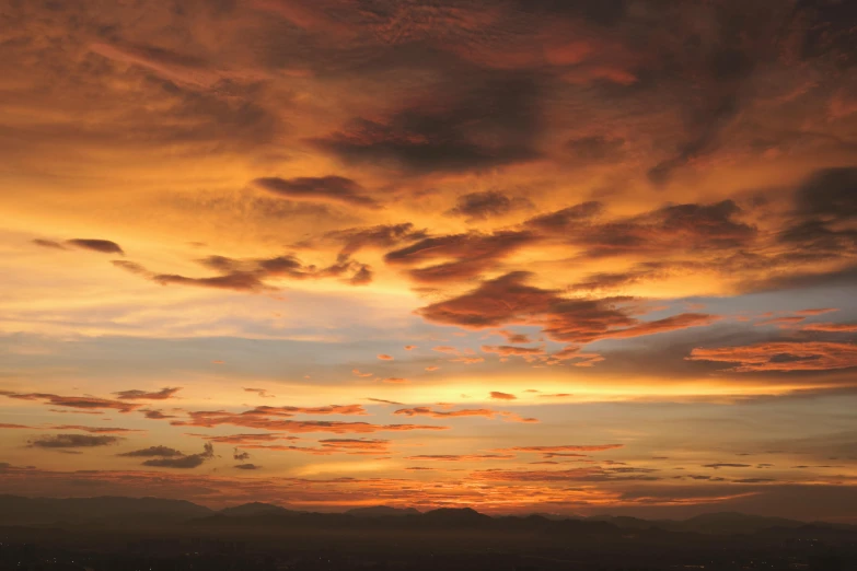 a sky view from the horizon shows orange clouds and a red sky