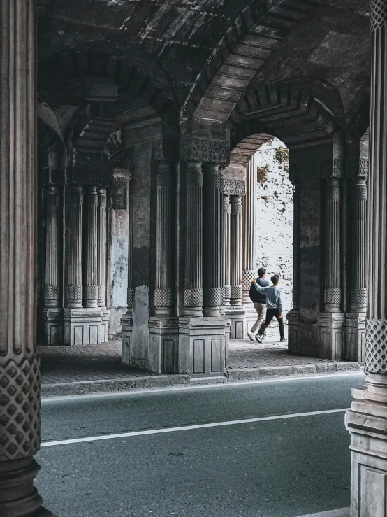 two people in a tunnel near the street