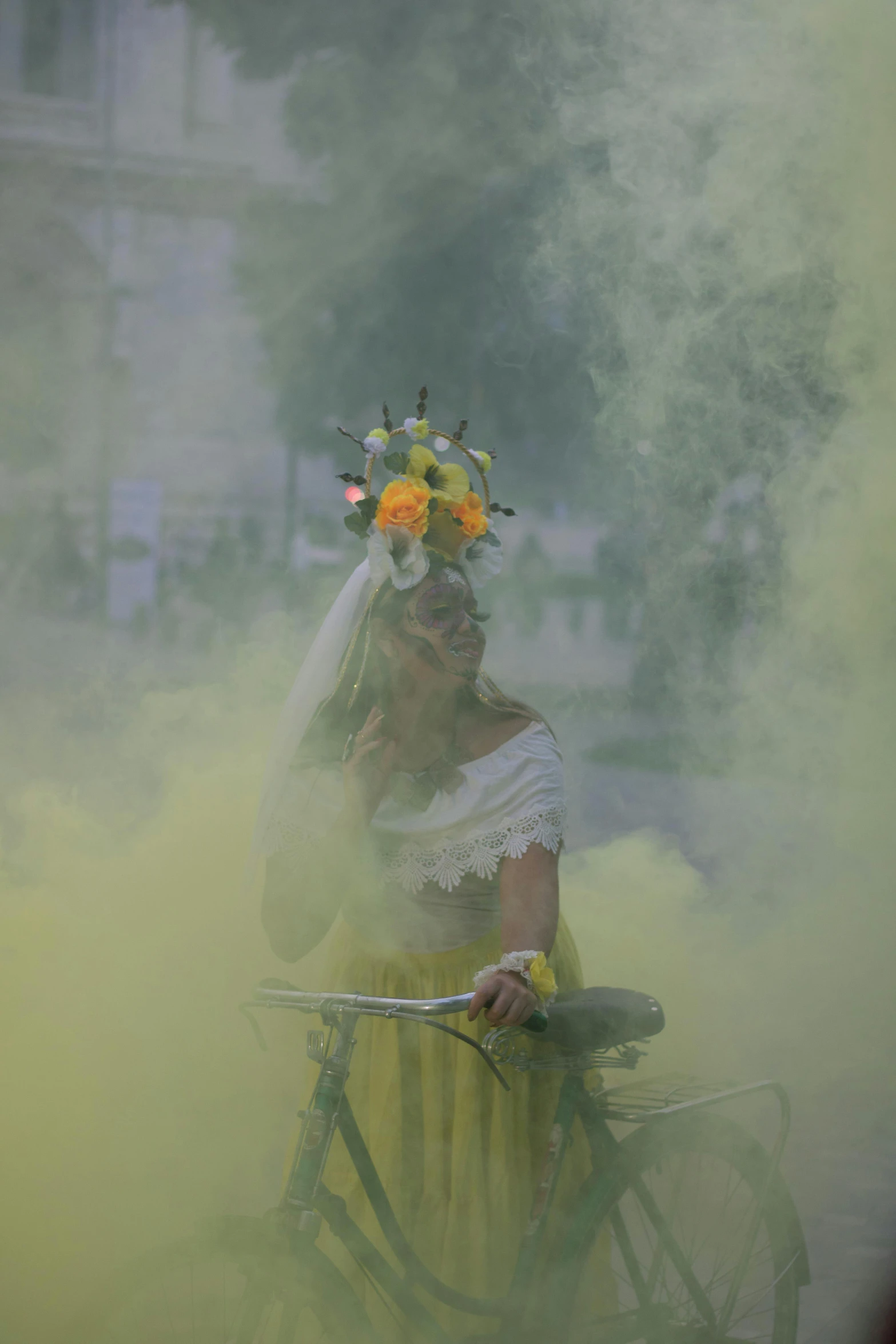 a woman with flowers on her head riding a bicycle