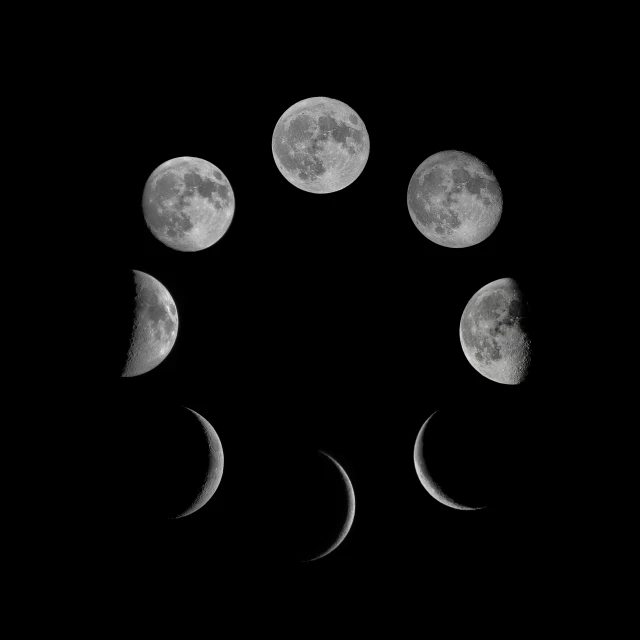 a cat paw print with five phases of the moon in different stages of phases
