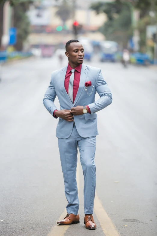 man in grey suit walking down road wearing red tie and brown shoes