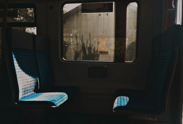 a view out of a passenger car with some empty chairs on the front