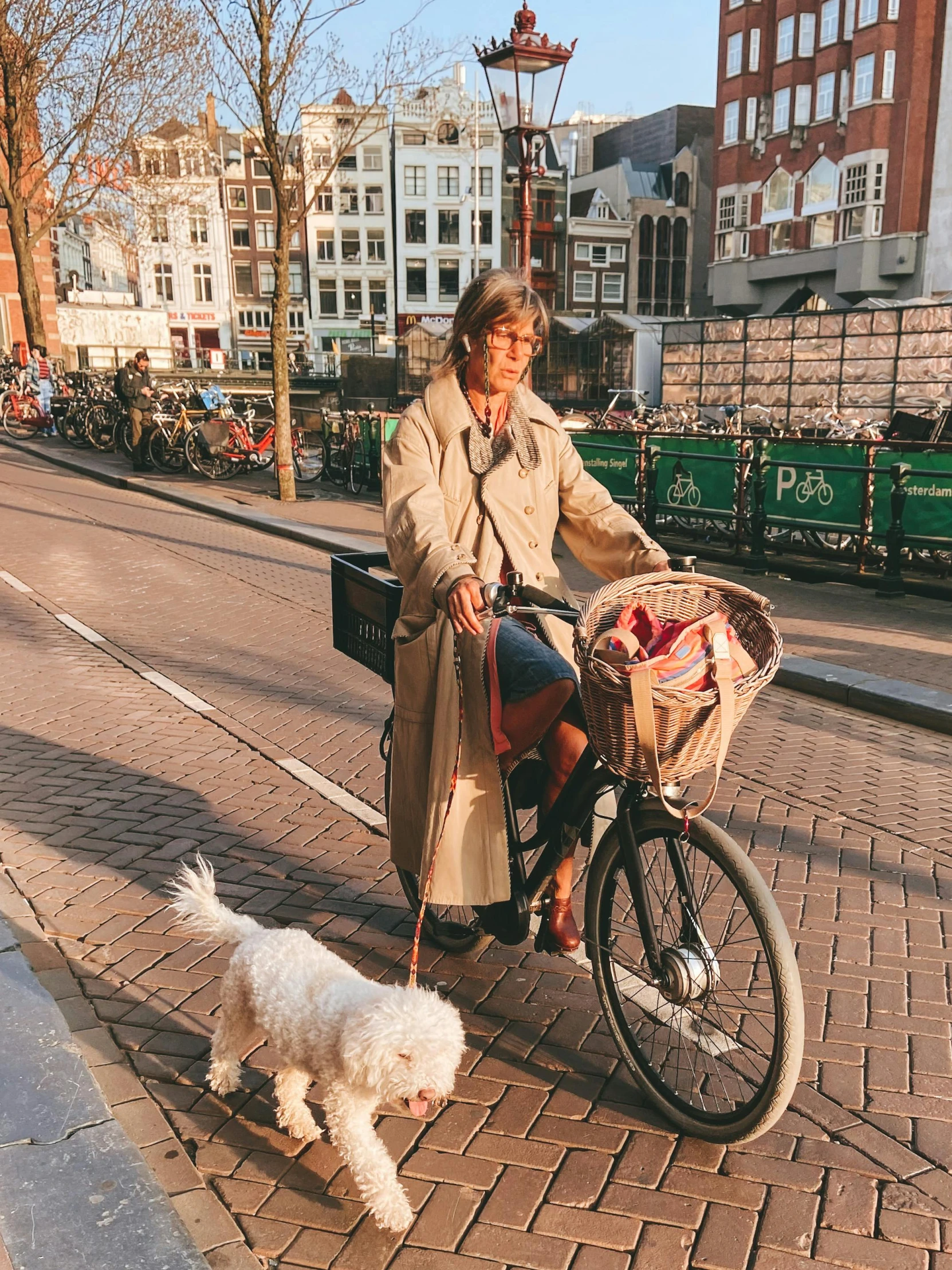 the woman is riding her bike with the dog