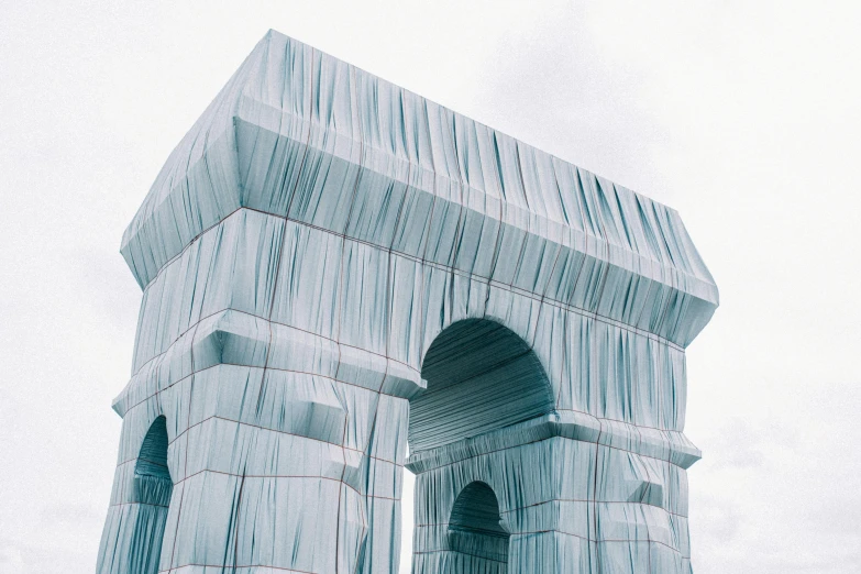 large white architectural structure with red stripes against sky