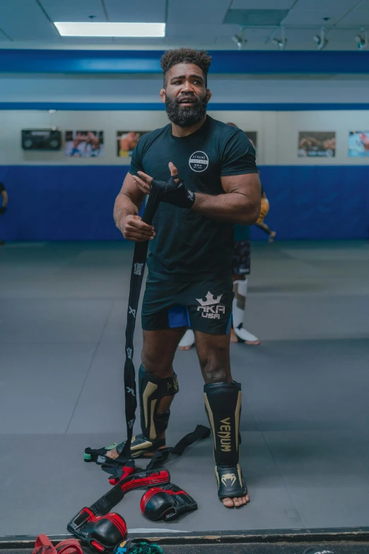 a man posing for a po with his wrestling gear