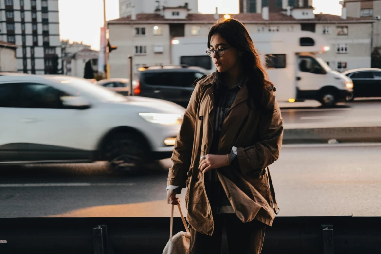 a woman walking down a street near a busy city