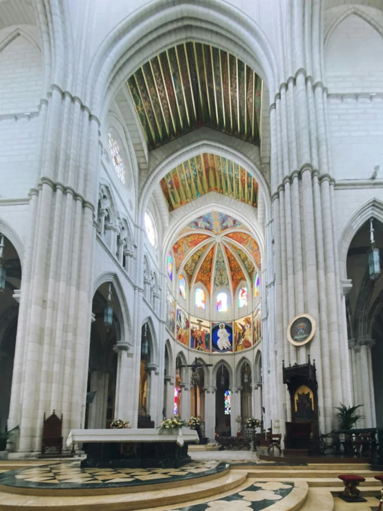 an indoor cathedral with high ceiling and stained glass windows