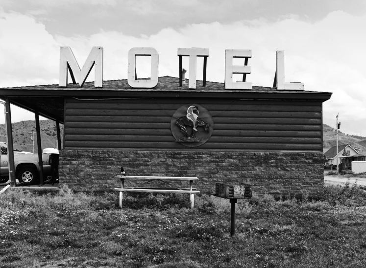 an old wooden building with signage that reads mom