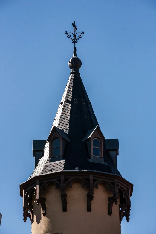 the steeple of an ornate building with a sky background