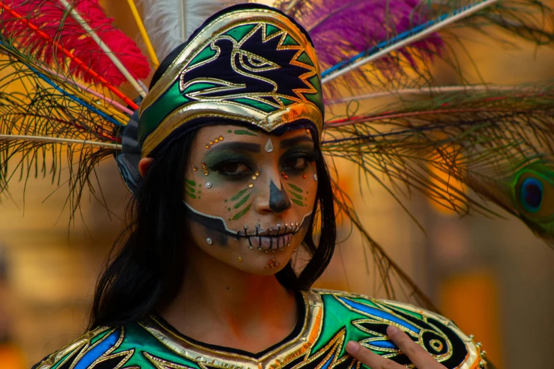 a woman in costume with painted face, feathers, and hair