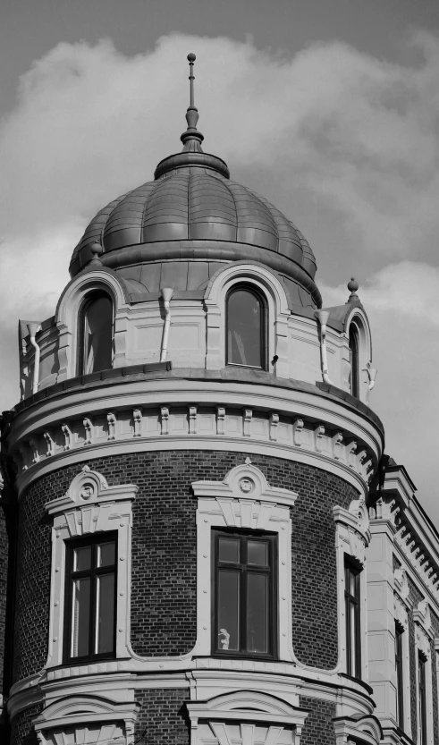 a black and white image of a building with large windows