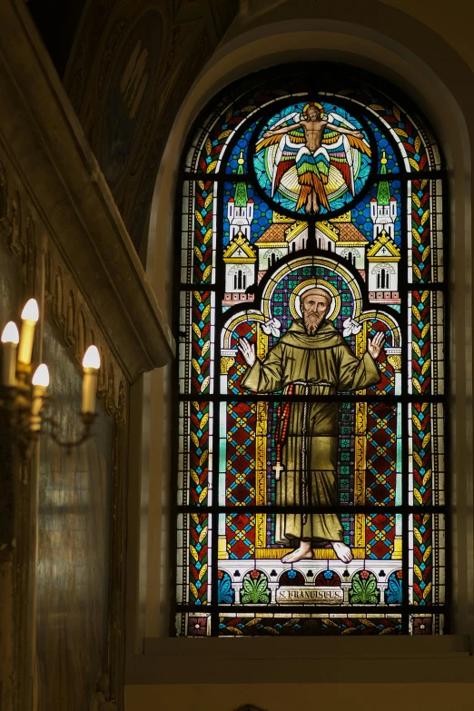 a stained glass window in a room with a light fixture