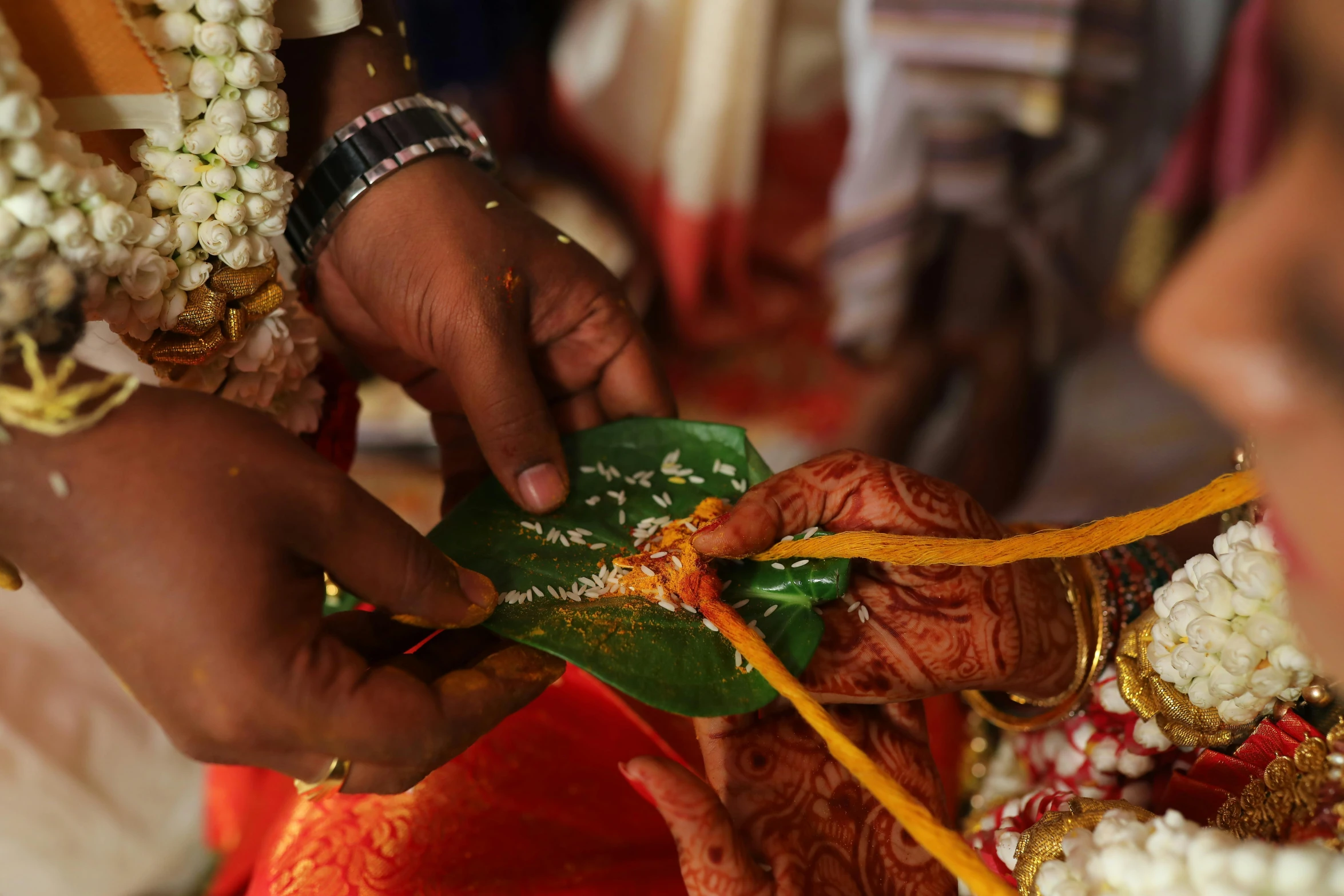 bride being screened with bangles by her bridal