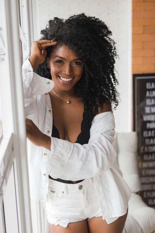 a black woman wearing white shorts and a white shirt