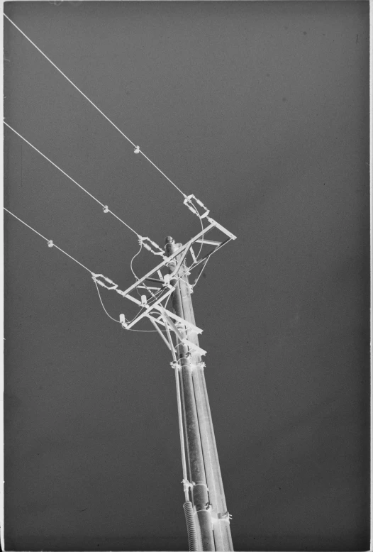 an old picture of a tower with wires and lights