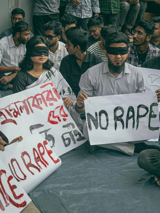 a crowd of people holding signs that read no escape and no rage