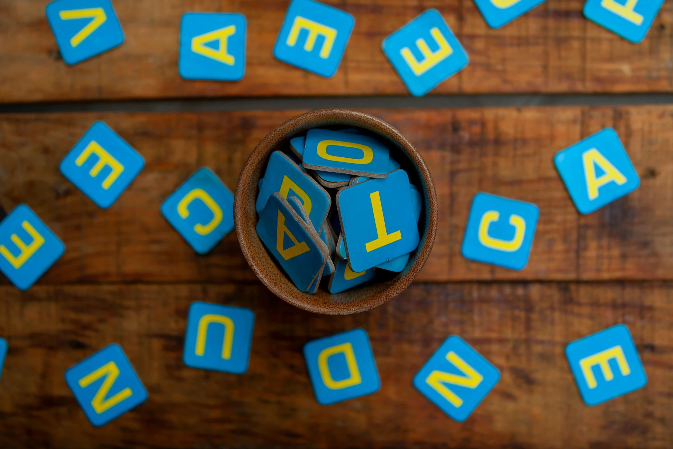 a close up of a cup on a table with blocks