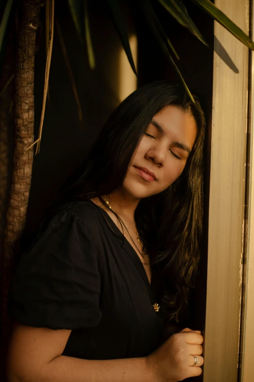 a woman in black shirt standing near doorway