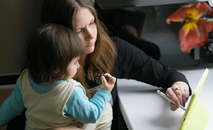 a mother and her daughter are enjoying a meal at a restaurant