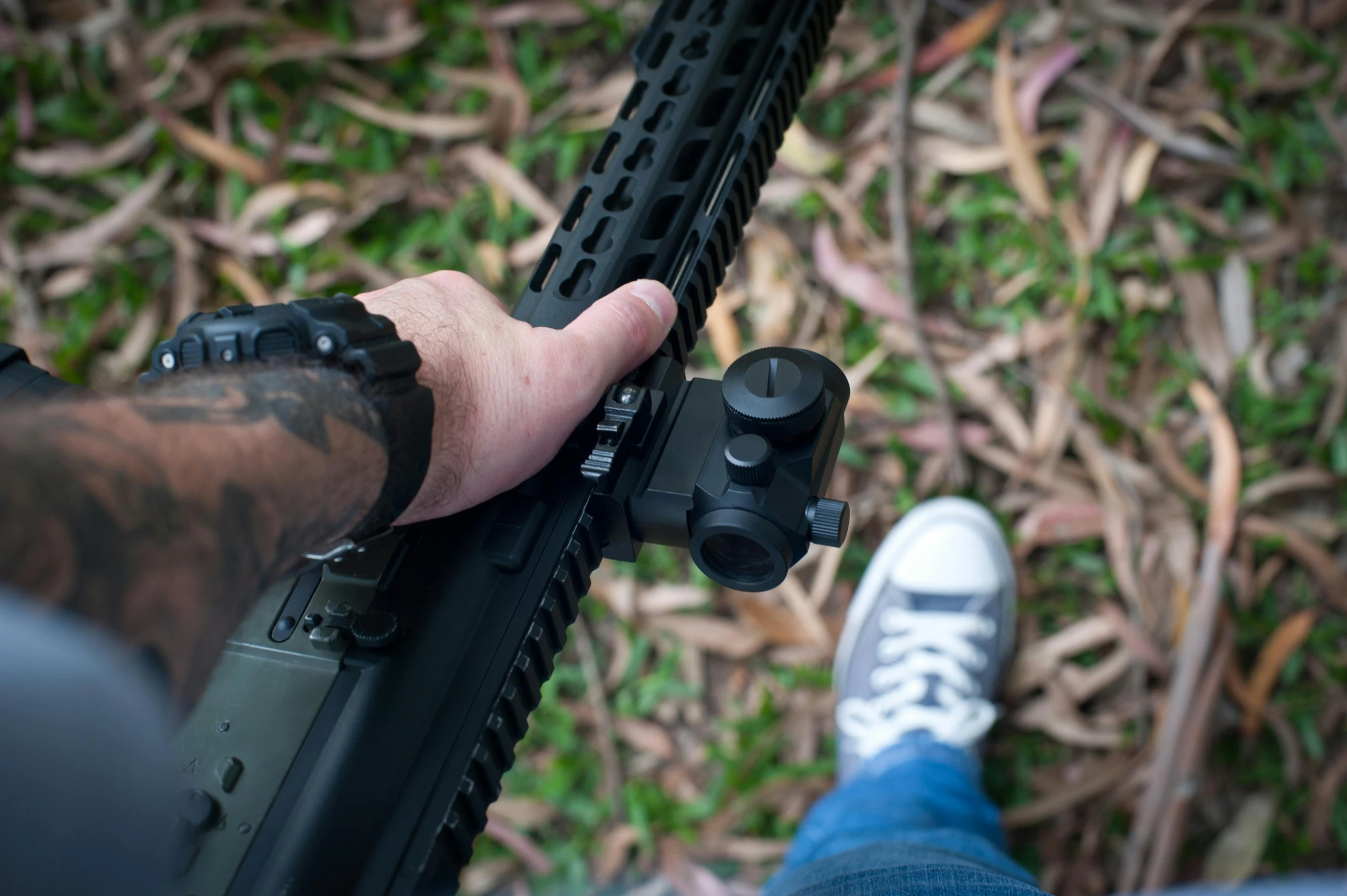 a person is holding an ake while standing close to an open rifle