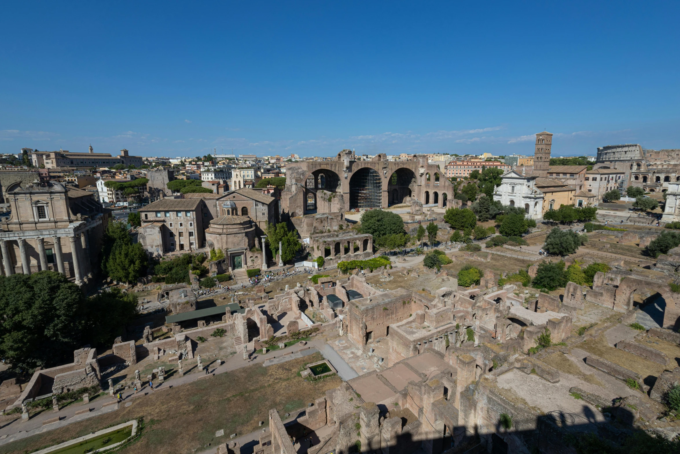 ancient ruins with a town in the distance