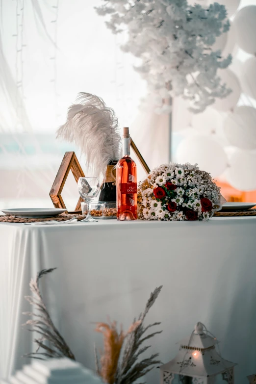 a table with a wine glass and two bottles