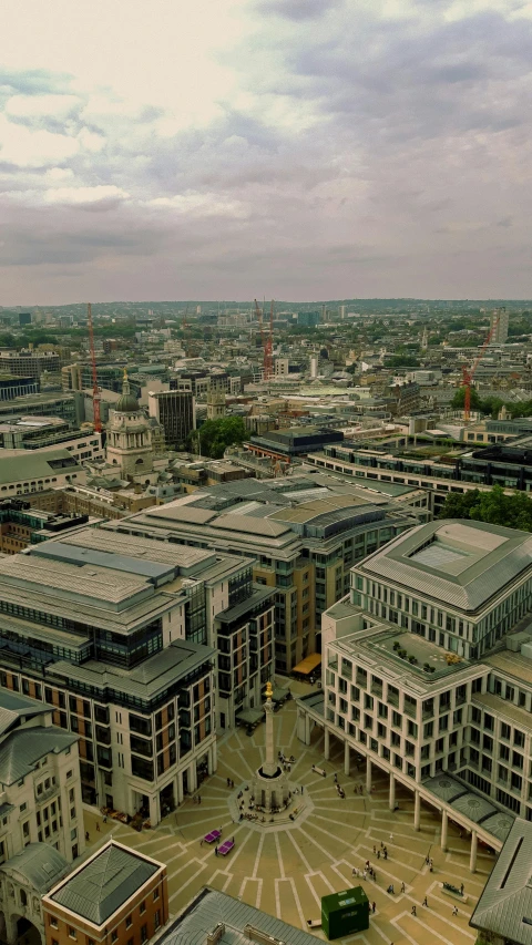 the aerial view shows buildings in a courtyard and the surrounding land