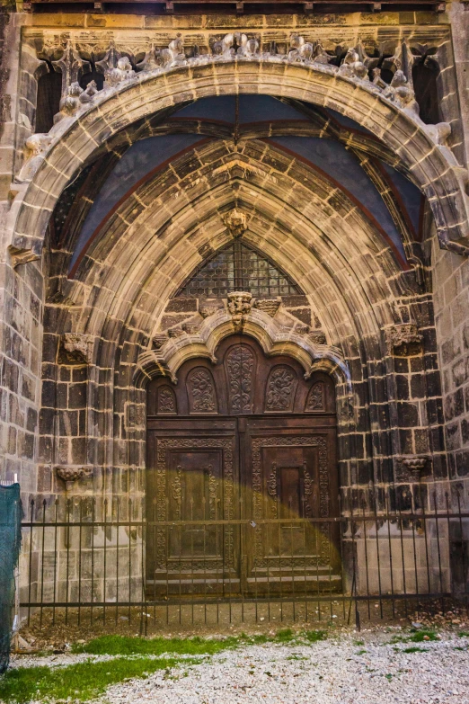 an ornate doorway with iron fence around it