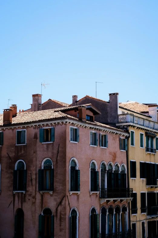 two tall buildings with windows and balconies next to each other