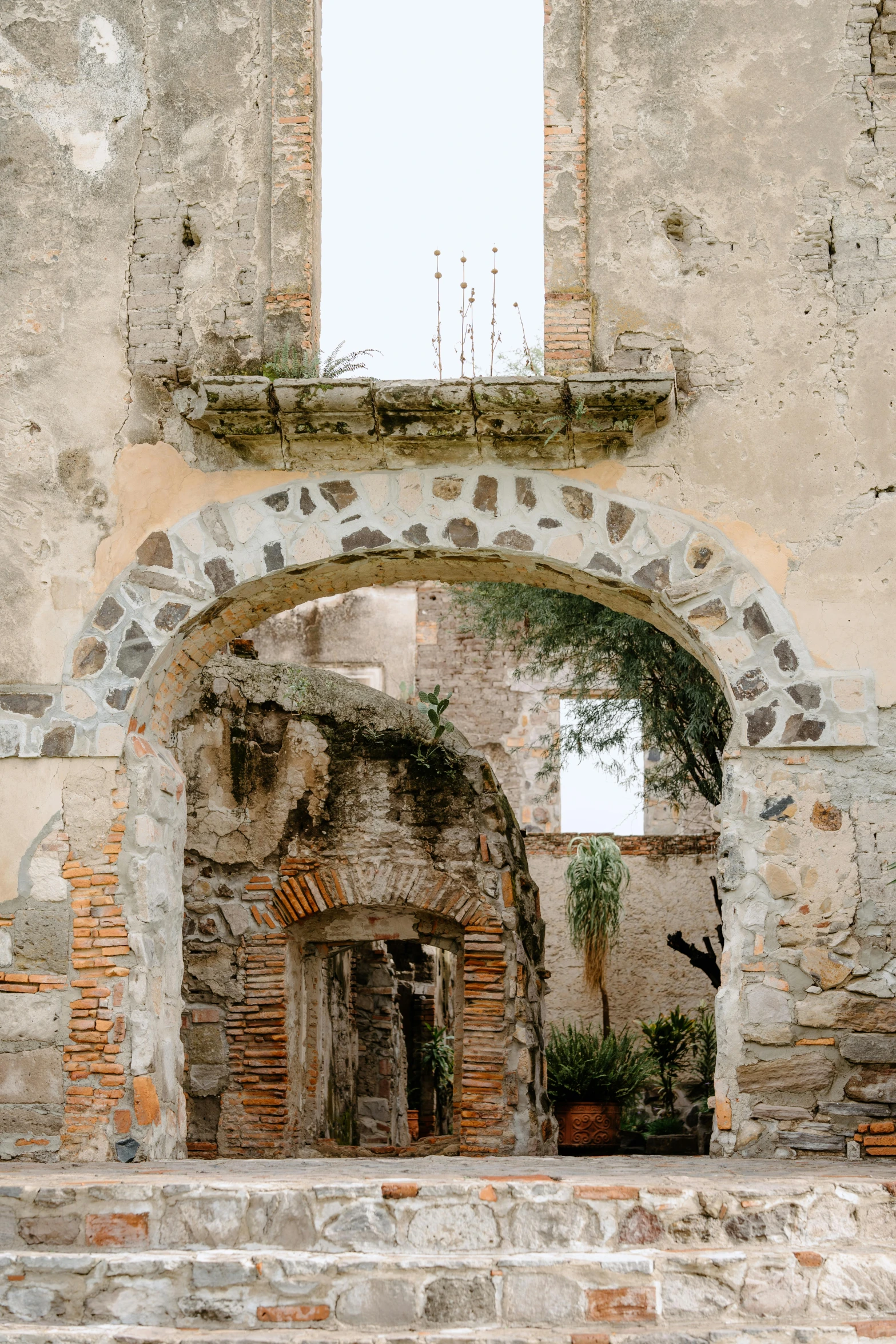 an old building with an arched doorway and stairs