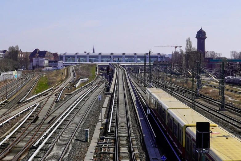 trains and tracks near each other and buildings on other sides