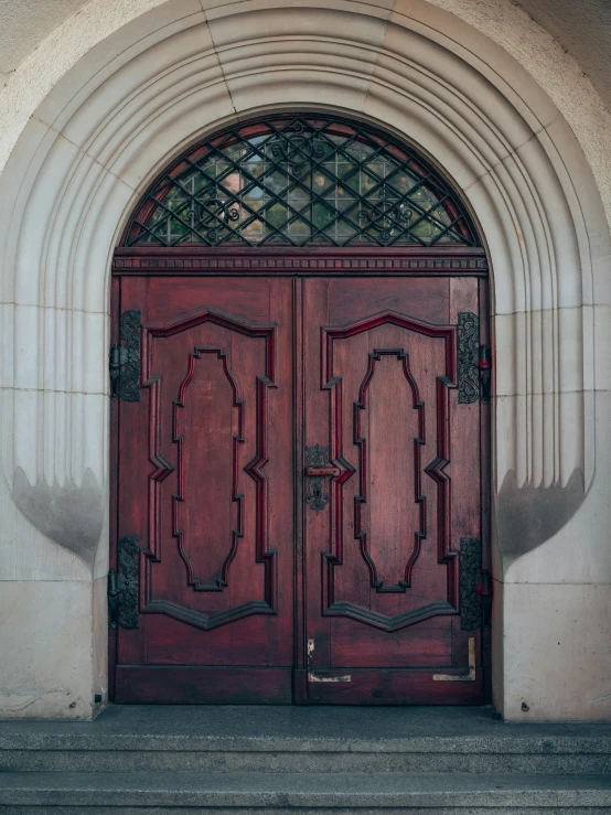 the front door is covered in ornamental glass