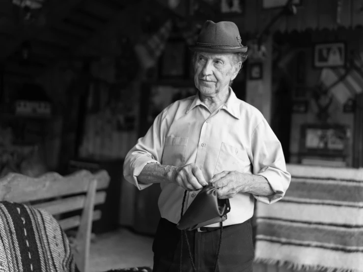 an old man standing next to some big beds