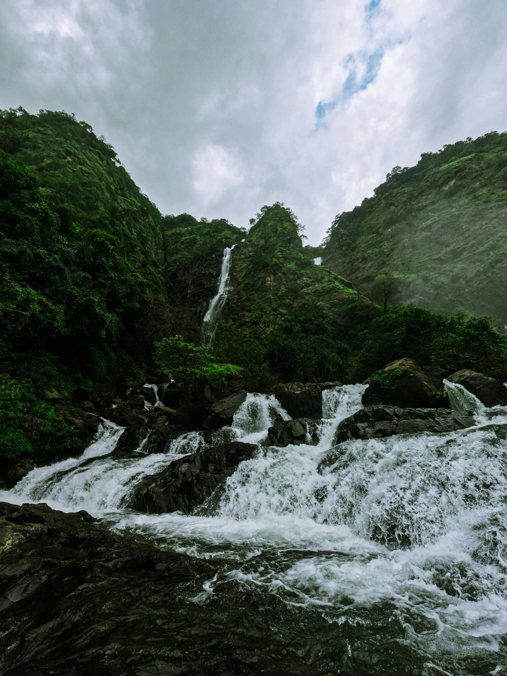 a group of waterfalls in the midst of some trees