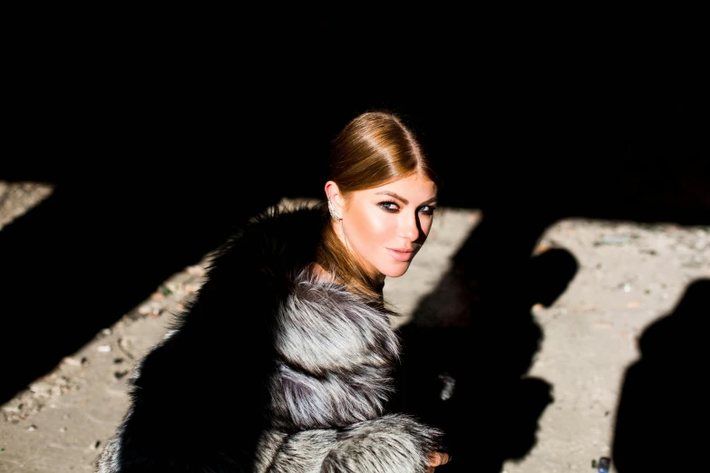 a woman with blonde hair standing in the dark