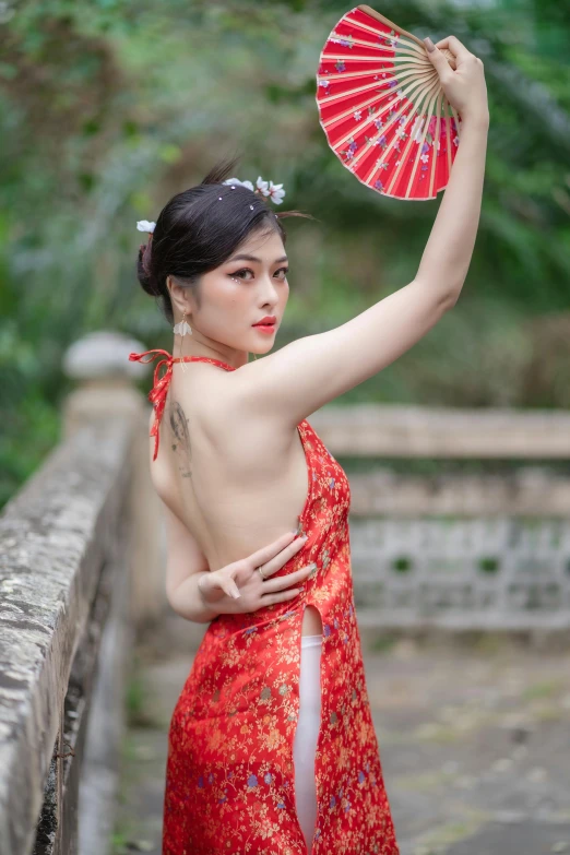 a woman with a dragon tattooed on her arm and wearing an elaborate dress