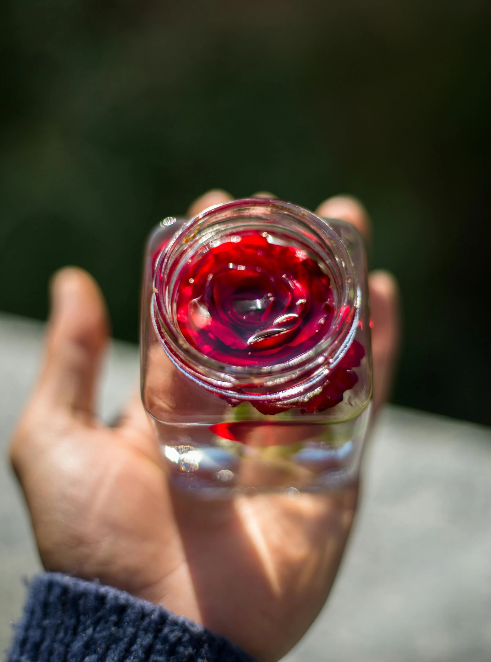 someone is holding an empty glass in their hand