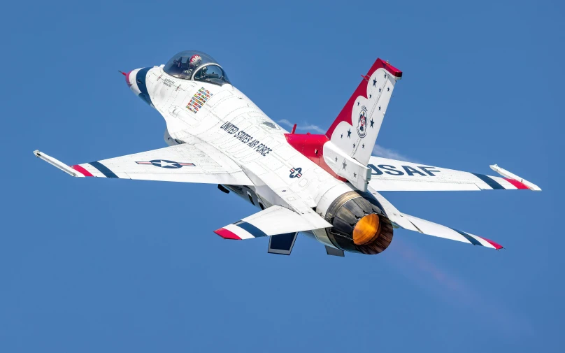 the white red and blue jet flies high up in the sky