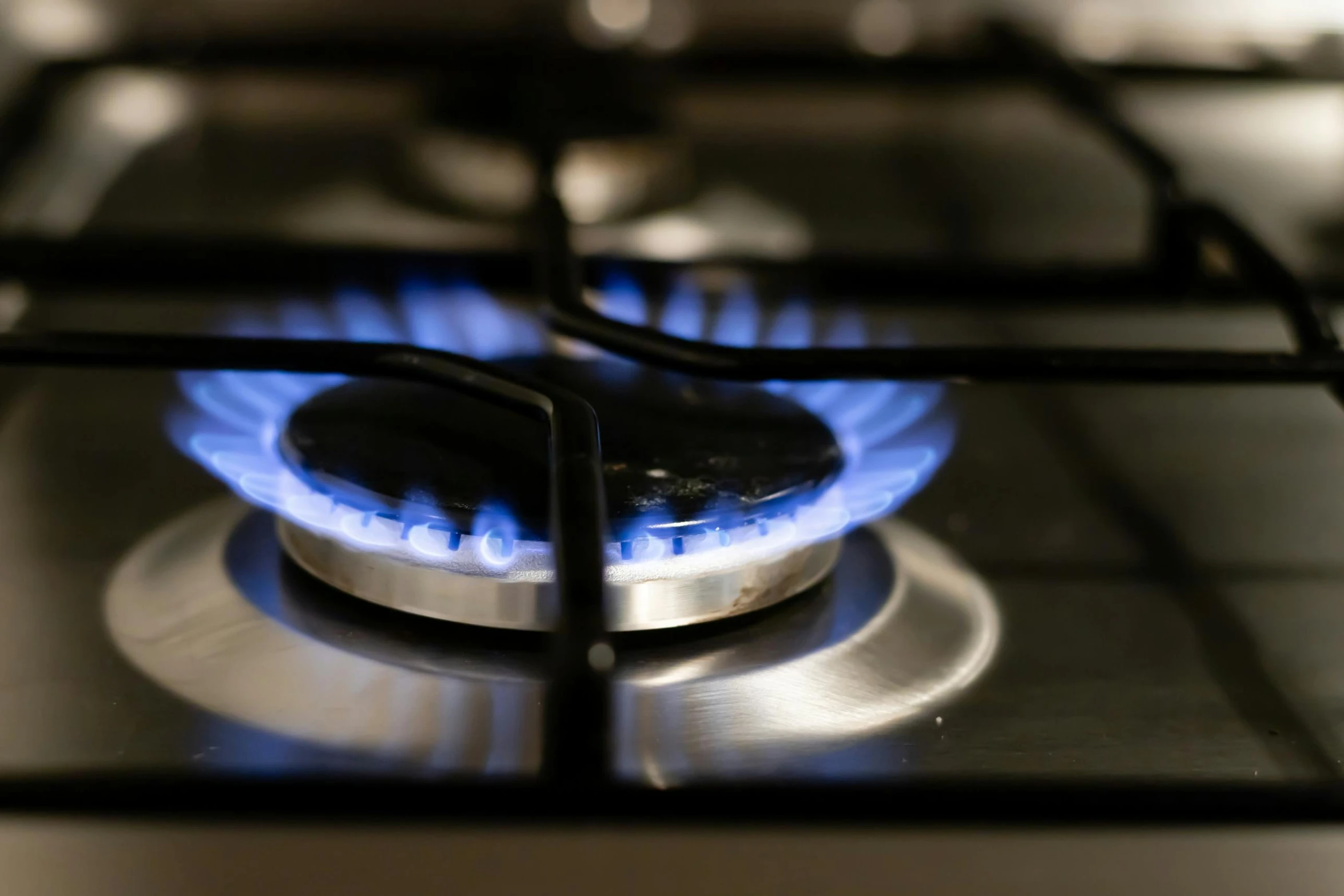 a blue flame in the middle of a gas stove top