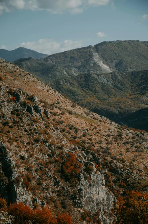 a view of a hillside near some mountains