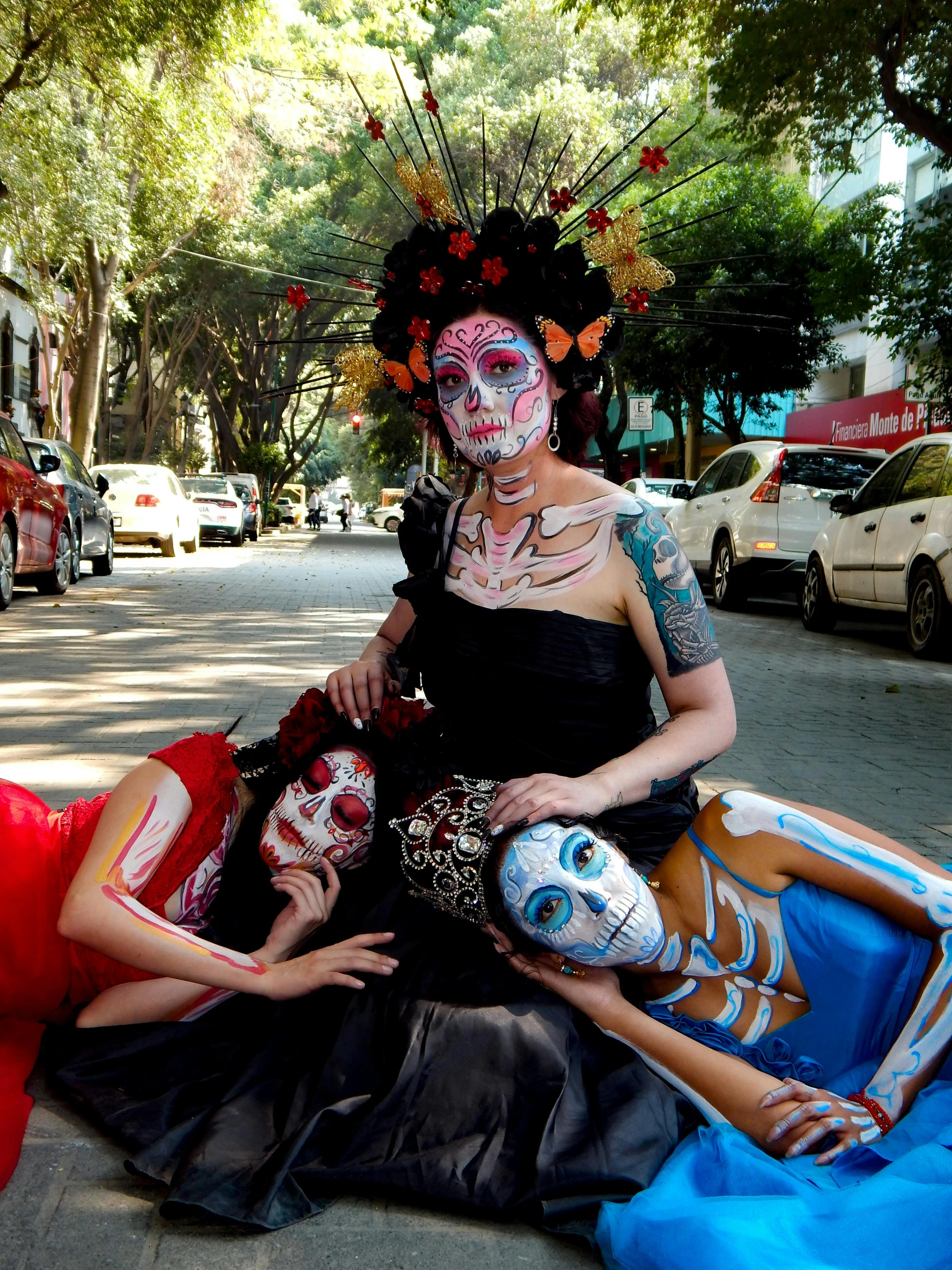 two women dressed as skeleton and skeletons posing on a street