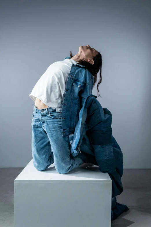 a man sitting on top of a stool next to another person