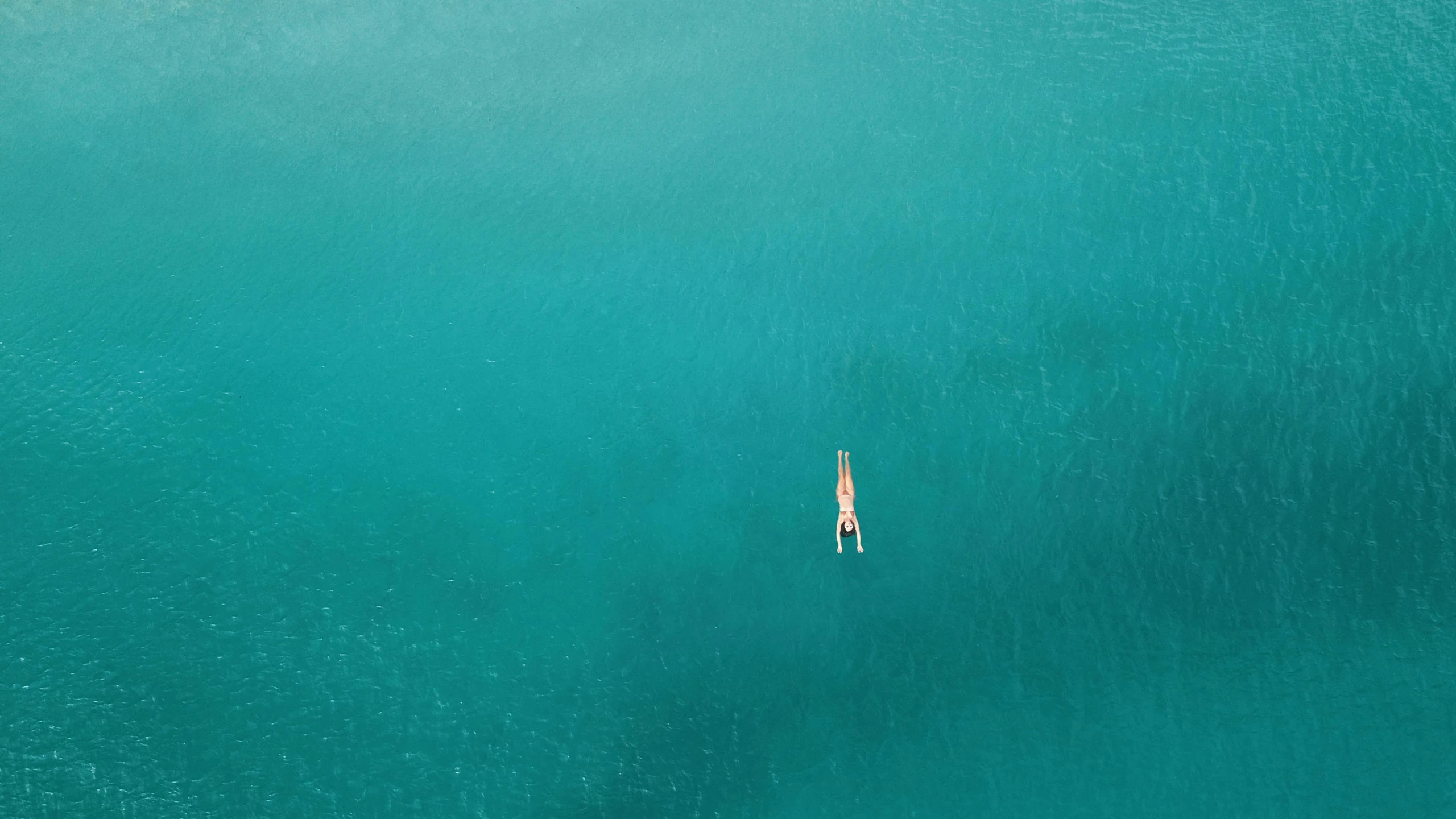 a lone sailboat in the middle of a large body of water