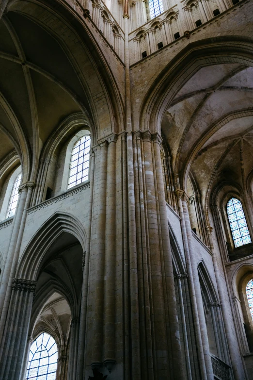 inside a gothic building with multiple windows and arches