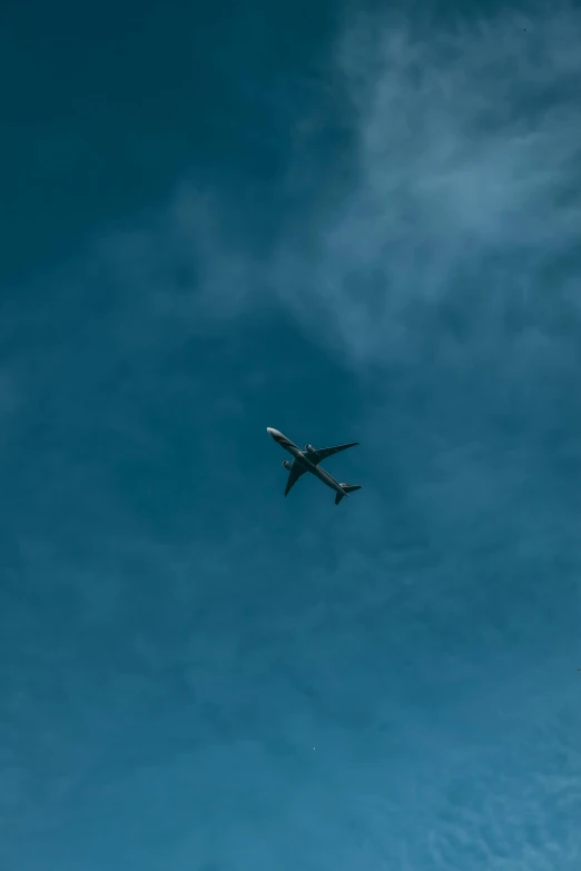 an airplane is flying through the blue sky