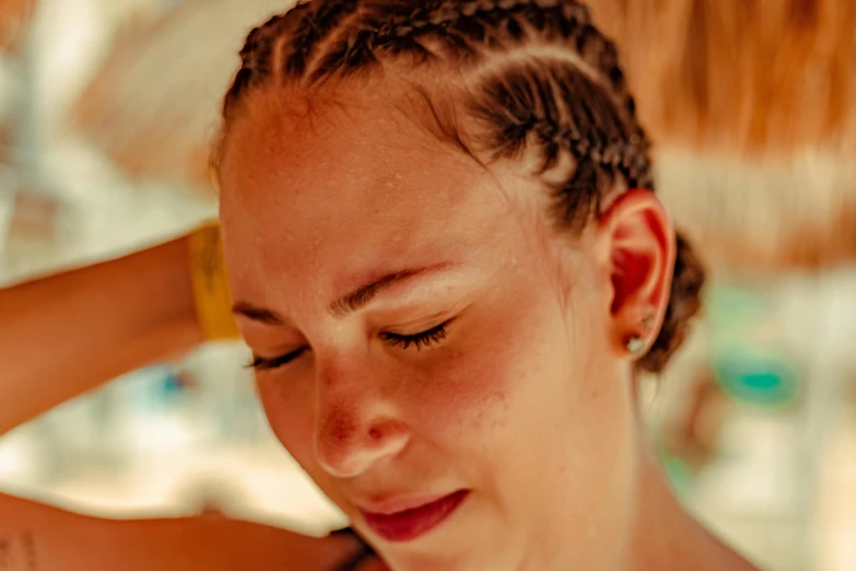 a girl is iding her hair outside in the sun